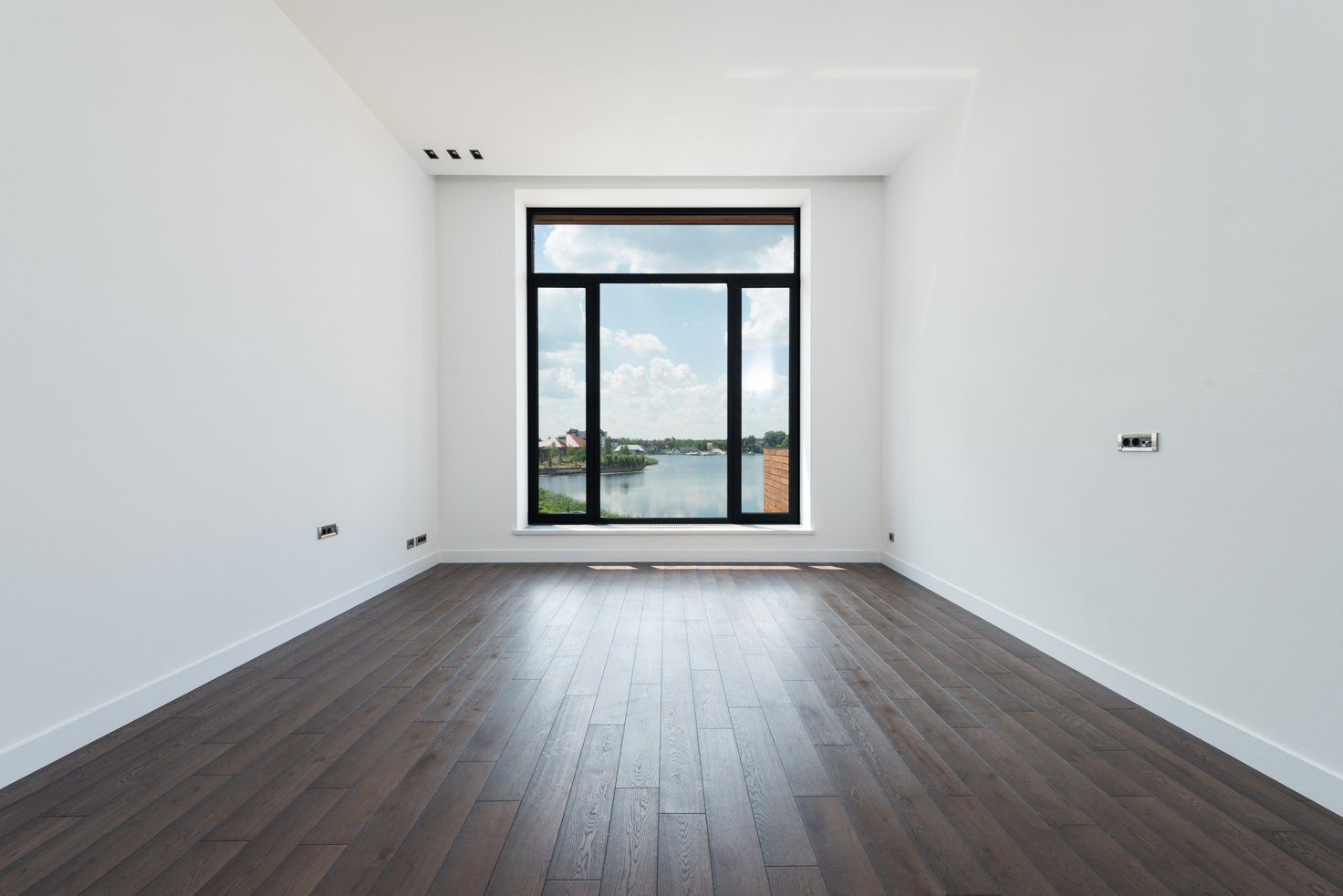 Spacious room with white walls and panoramic windows